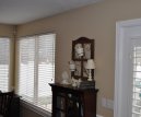 Custom wall in a family room with double windows and patio door