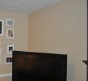 Custom wall color in a family room next a tv and fireplace mantel