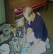 This picture shows Lynn Seely choosing colors to use in the woodgraining process on the interior metal doors the church