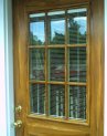 Closeup view upper portion of woodgrained door at south entrance of beauty salon