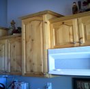 Side view of knotty alderwood kitchen cabinets that were refinished.