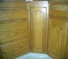 Closeup view of lower oak kitchen cupboard doors before they were refinished.