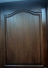 Closeup of refinished cherrywood kitchen cupboard door.