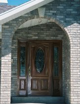 Front view of home with fiberglass door with side panels