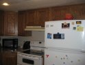 Old oak cabinets above stove before refinishing