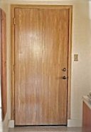 Interior metal door woodgrained to match kitchen cabinets