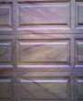 Closeup of woodgrained panels on garage door.