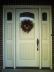 This is closeup view of a two-tone painted wood entrance door.