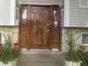 This is a closeup view of a woodgrained exterior metal nine-panel door.