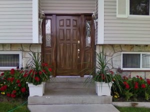 This exterior nine-panel door with side panel has been woodgrained to match the colors of the exterior paneling and stone.