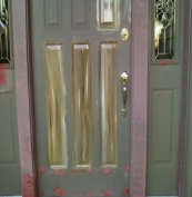 This metal door and wood casing had extensive damage that was repairred and covered with Bondo.